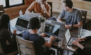 group of people using laptop computer