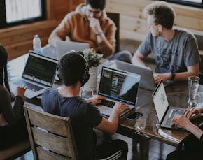 group of people using laptop computer