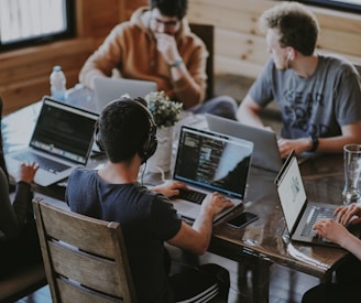 group of people using laptop computer