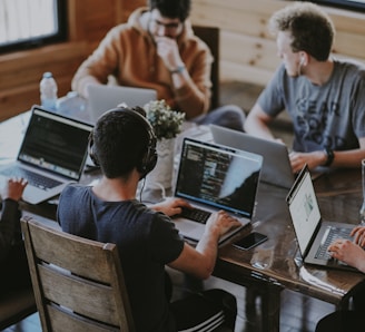 group of people using laptop computer