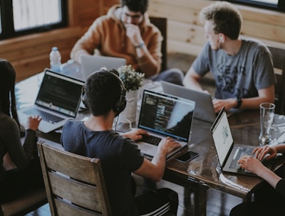 group of people using laptop computer