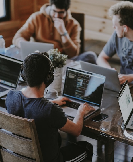 group of people using laptop computer