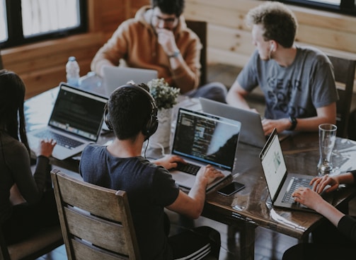 group of people using laptop computer