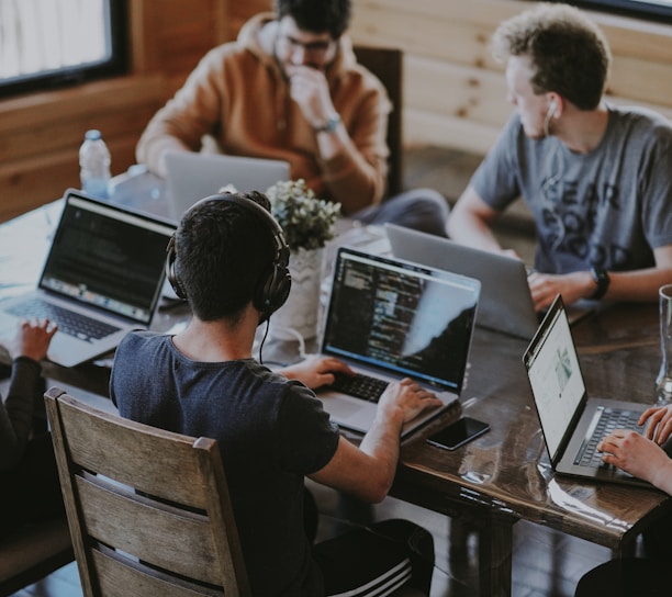 group of people using laptop computer