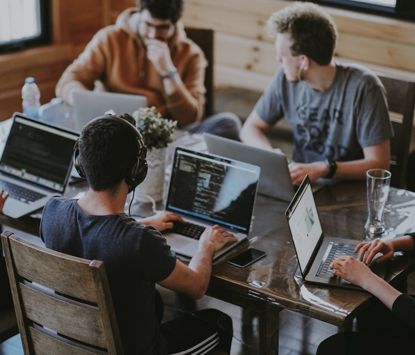 group of people using laptop computer