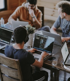 group of people using laptop computer