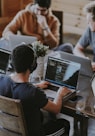 group of people using laptop computer