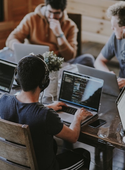 group of people using laptop computer