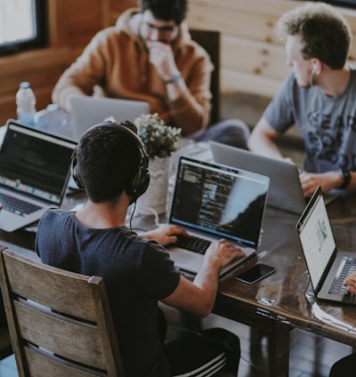 group of people using laptop computer