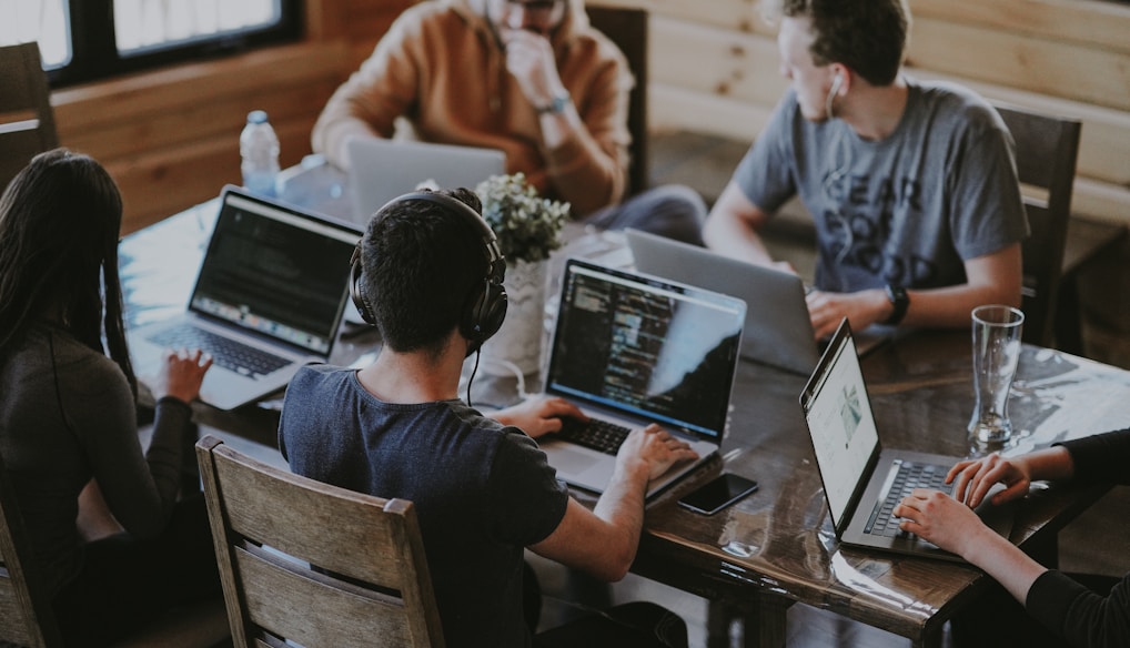 group of people using laptop computer