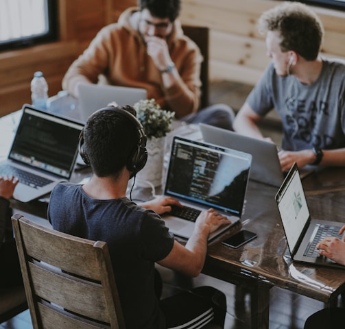 group of people using laptop computer