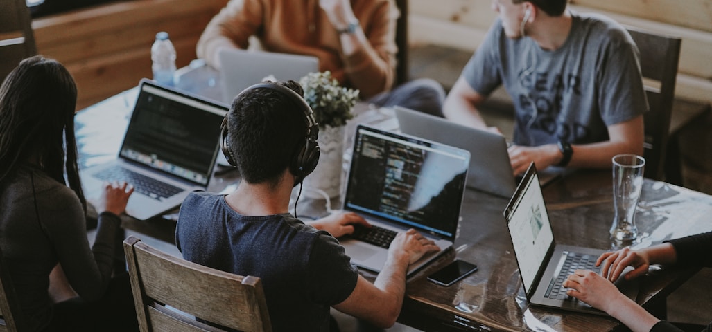 group of people using laptop computer