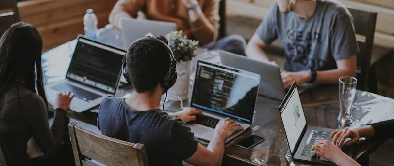 group of people using laptop computer