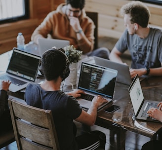 group of people using laptop computer