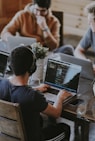 group of people using laptop computer