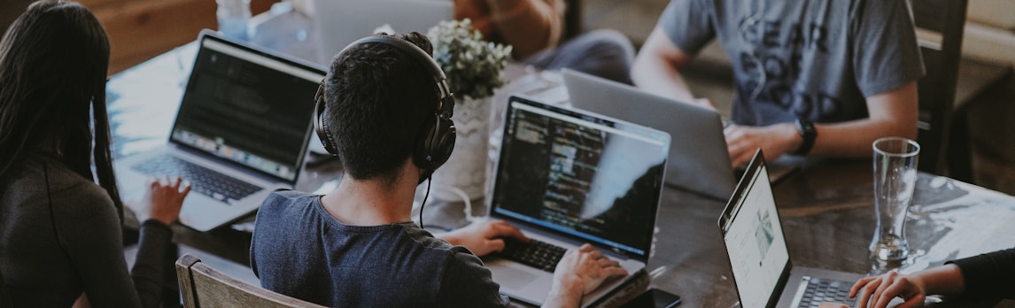 group of people using laptop computer