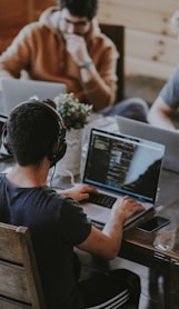 group of people using laptop computer