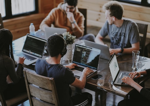 group of people using laptop computer