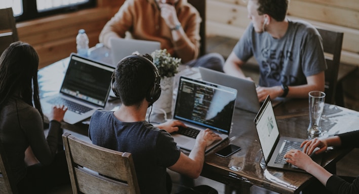 group of people using laptop computer