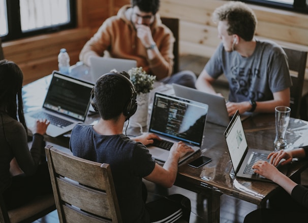 group of people using laptop computer