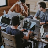 group of people using laptop computer