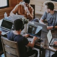 group of people using laptop computer