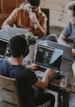 group of people using laptop computer