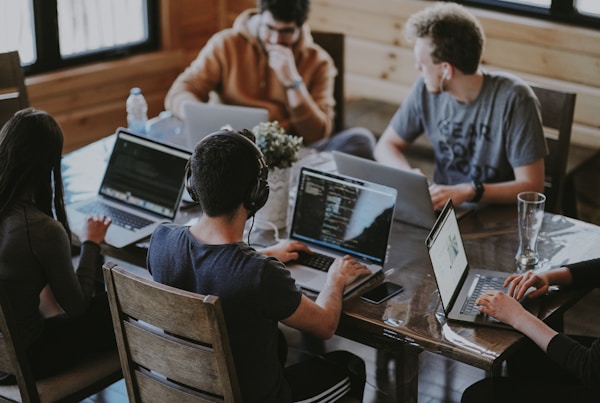 group of people using laptop computer