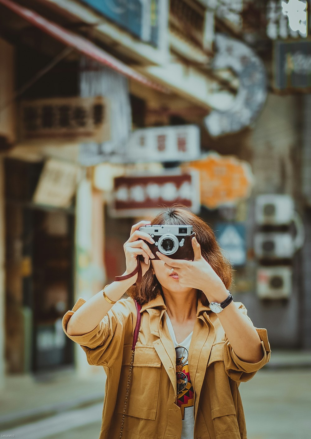 woman holding camera while capturing