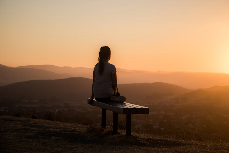 A person taking a quiet, reflective moment outdoors