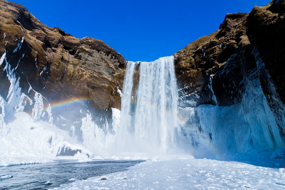 frozen waterfall on brown mountain