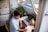A person discussing plans with a notepad and laptop in a cozy office space.