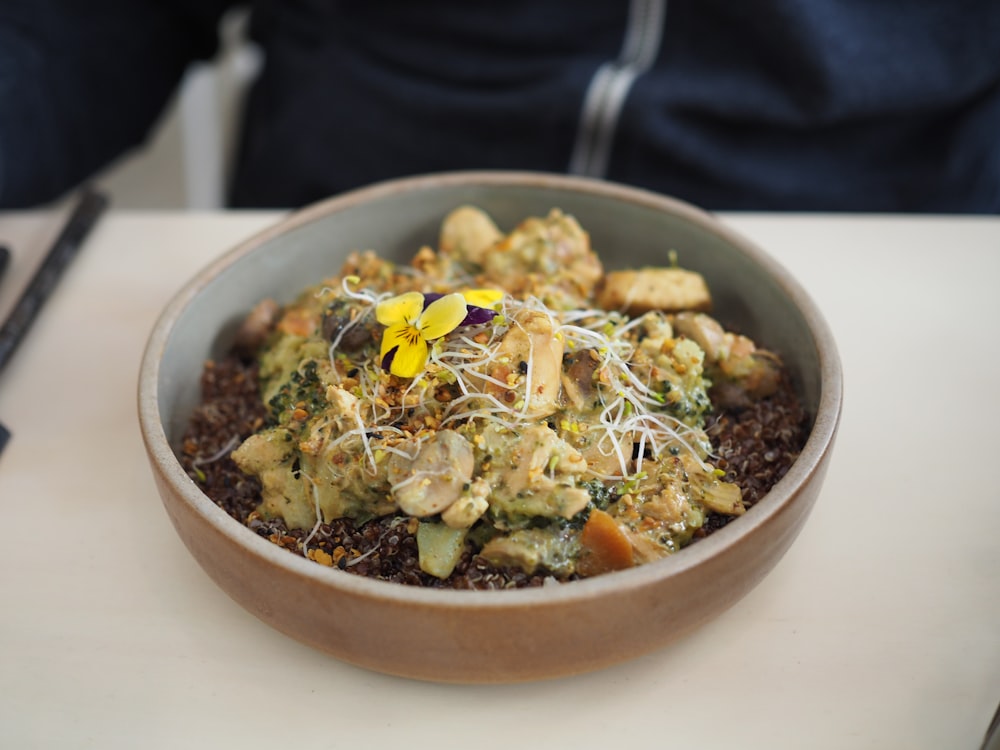 sliced food and vegetables in round brown ceramic bowl