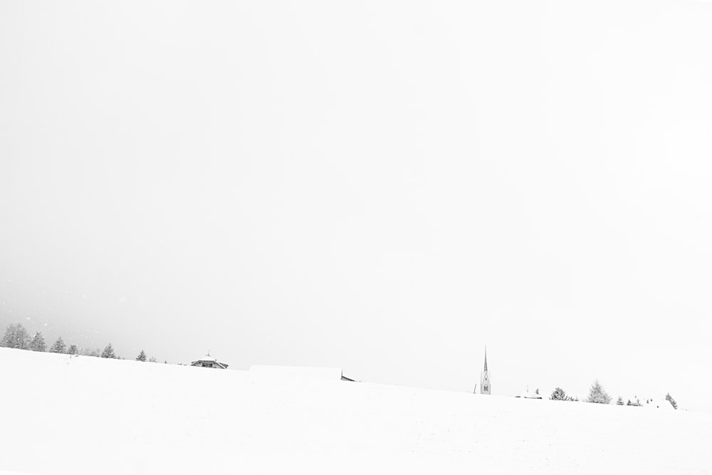 a man riding a snowboard down a snow covered slope