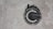 A stencil graffiti of a copyright symbol is painted on a rough concrete surface. The symbol is depicted in black with what appears to be skyline-like shapes emanating from the top half, giving it a distinctive and creative twist.