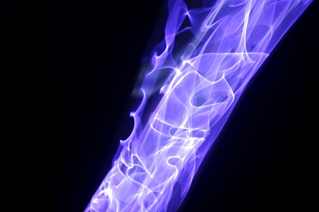 Abstract flowing energy waves in violet and indigo hues symbolizing prana movement.