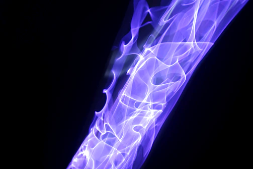 Abstract sound waves in cold silver and deep blue hues flowing over a dark background.