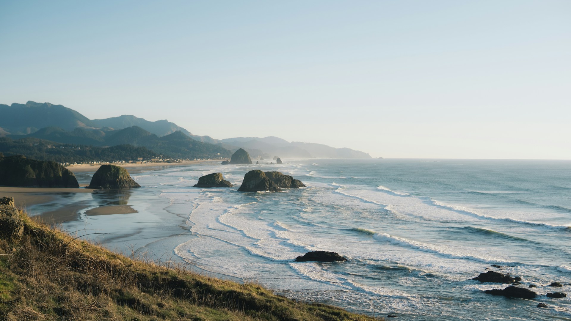 a view of a beach with mountains in the background