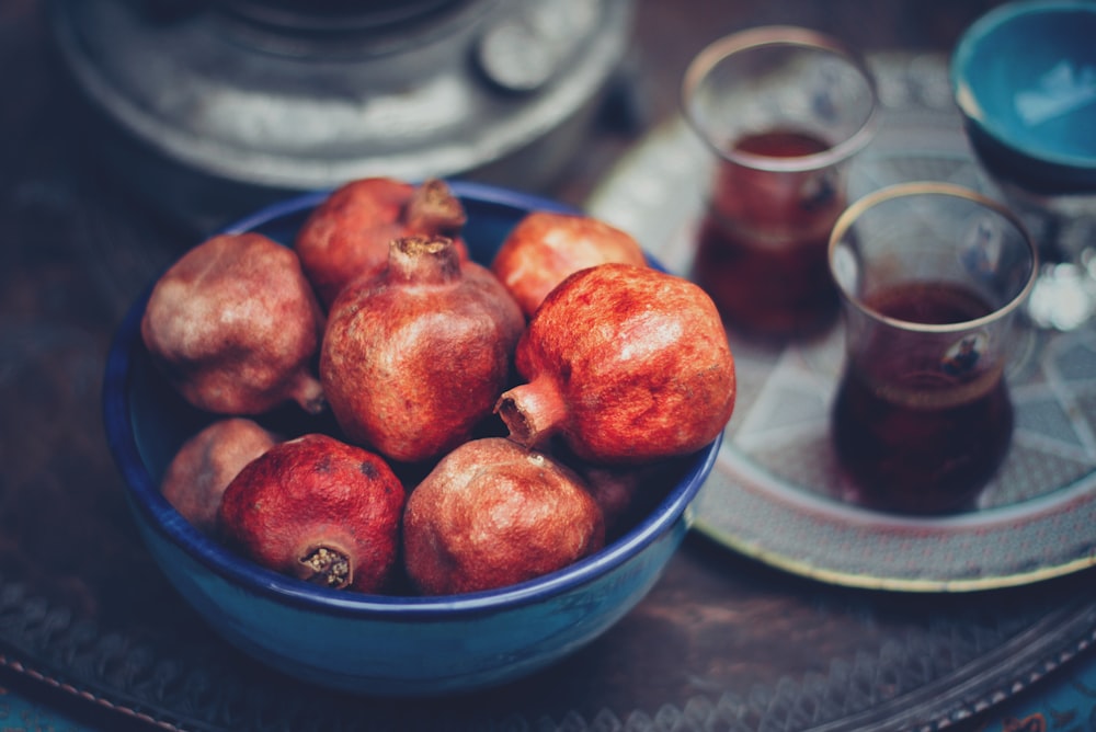 red fruits in blue ceramic bowl