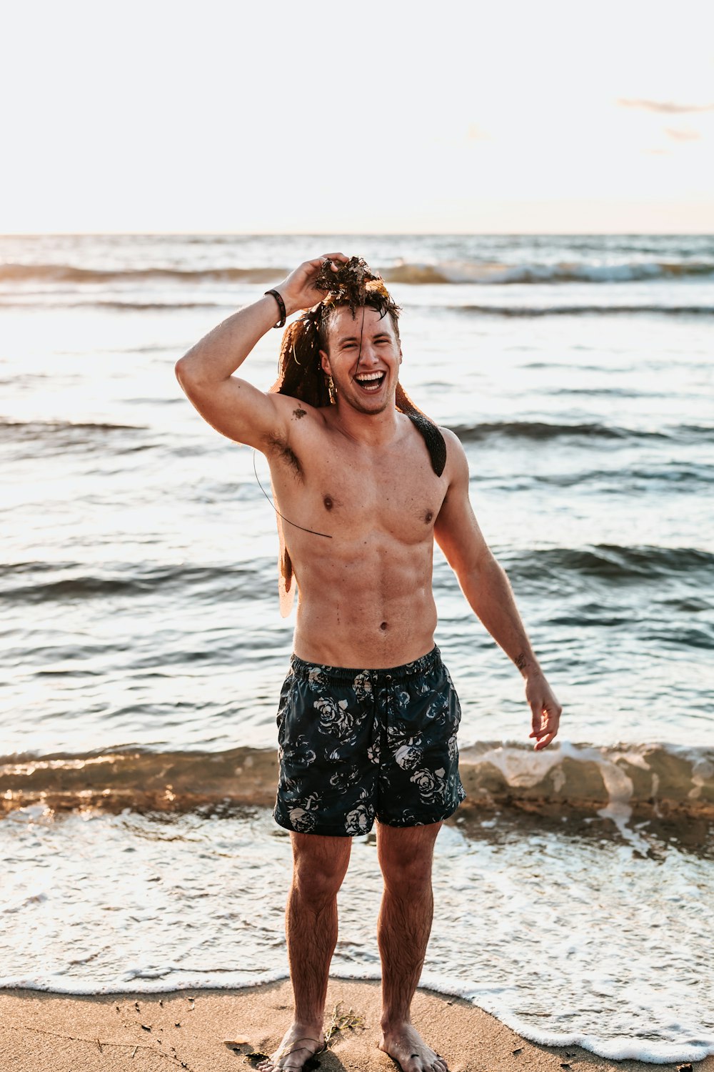 man standing on shore during daytime