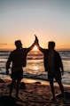 two men clapping each other on shore