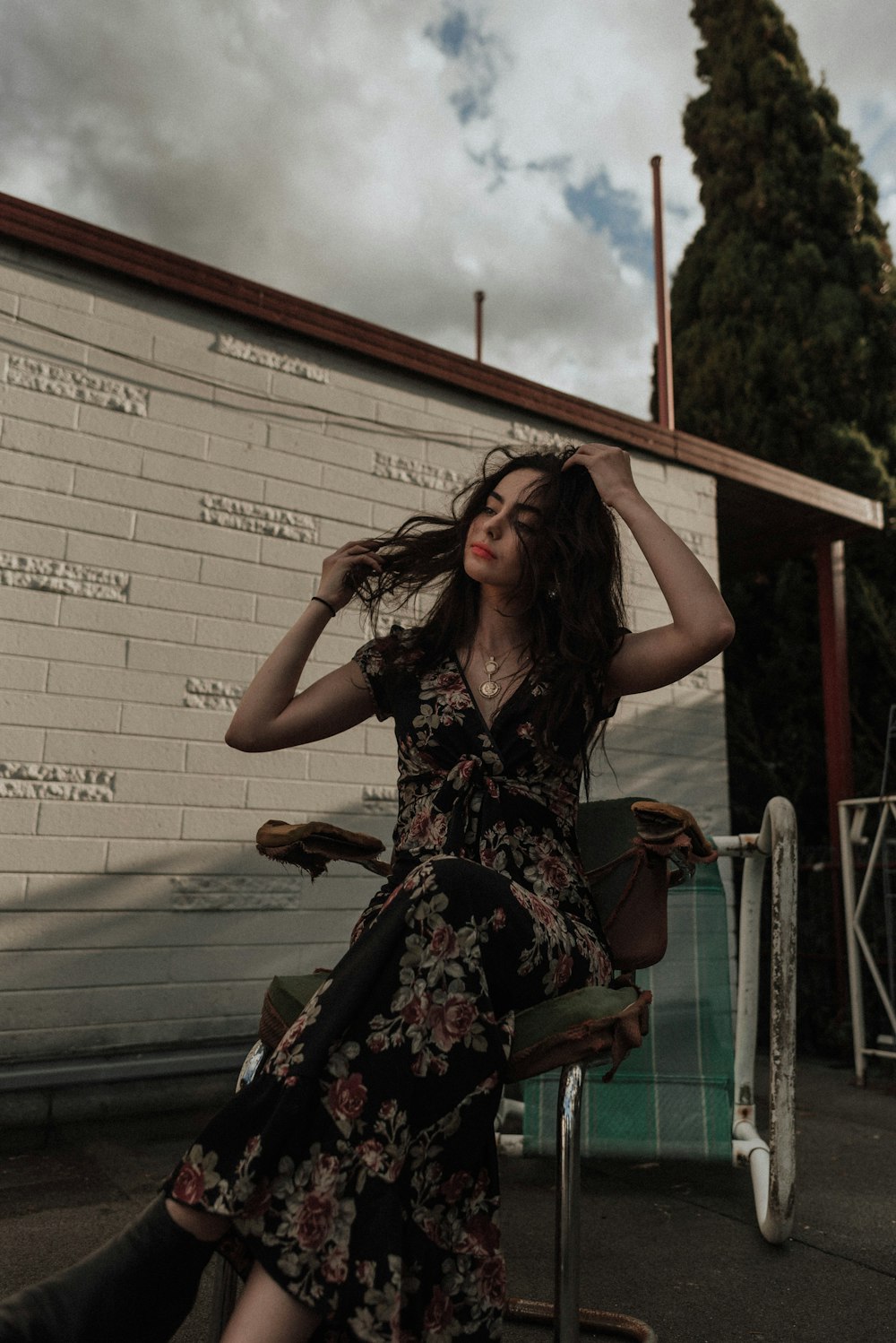 woman in black and gray floral V-neck dress