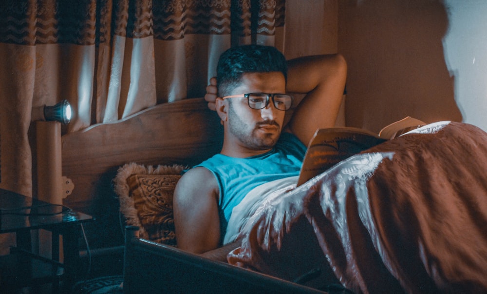 a man sitting in a chair with a laptop