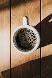 white ceramic mug on brown wooden surface