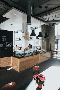 pink flowers decor near clear display shelf