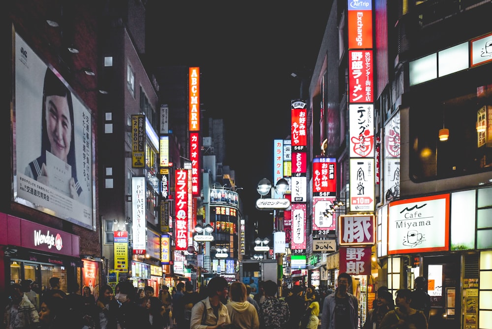 people walking on street between buildings