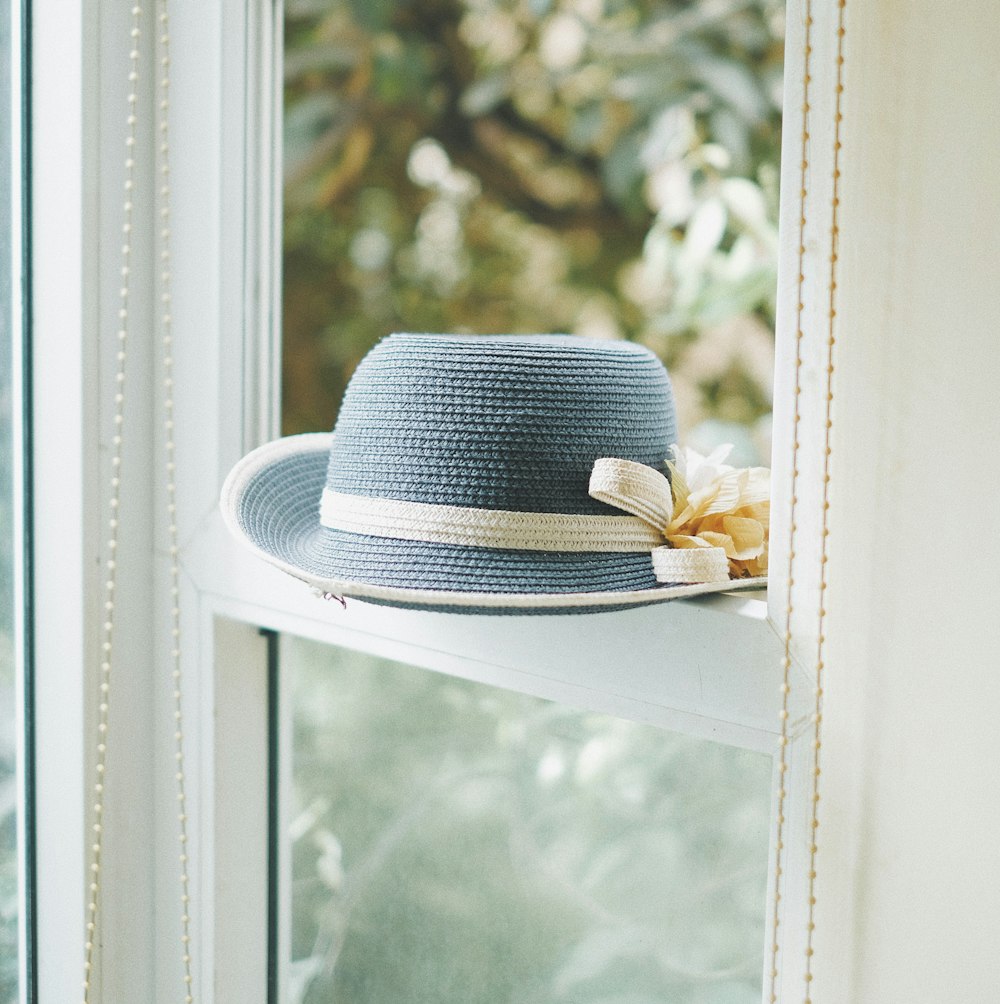 grey knitted hat on window