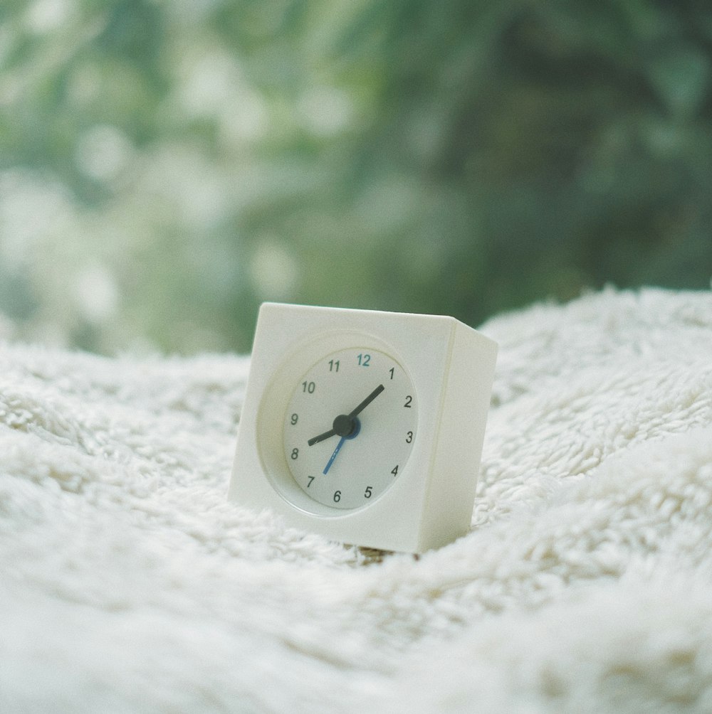 white framed analog clock