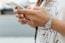 woman holding iPhone during daytime