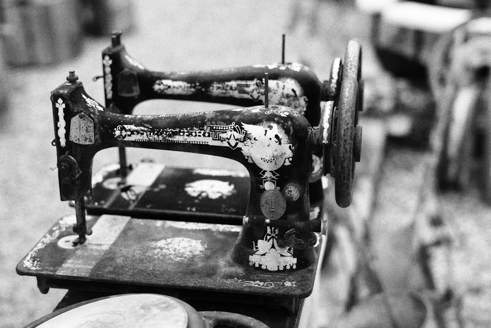 grayscale photo of two sewing machine